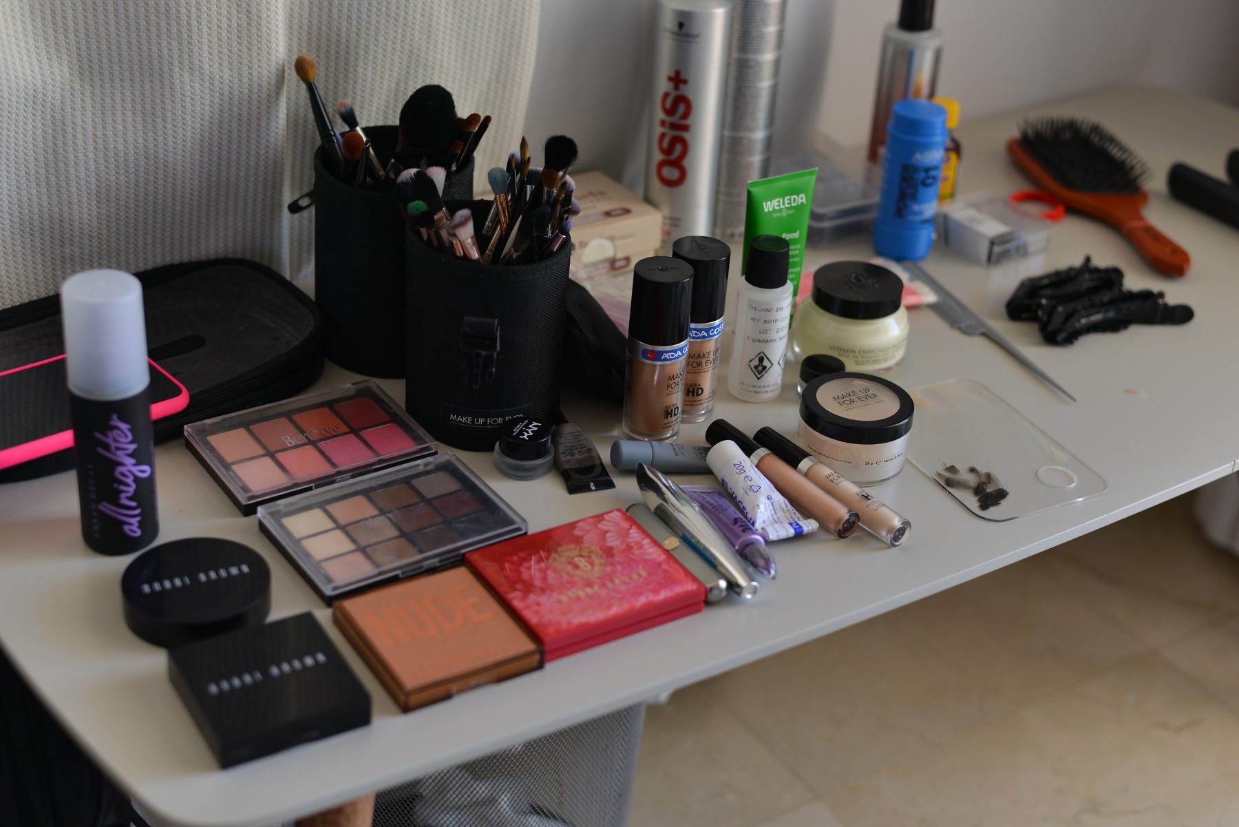Maleta de maquillaje profesional con brochas, bases y paletas preparadas